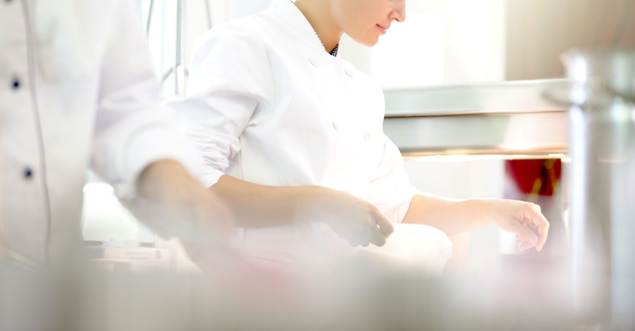 A chef finishing a dish